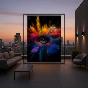 May include: A framed art print featuring a close-up of a human eye with a vibrant explosion of colorful paint. The eye is teal, and the paint bursts in shades of yellow, red, blue, and purple against a black background. The artwork is displayed on a rooftop patio.
