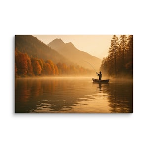 May include: A canvas print depicts a serene lake scene with a person fishing from a small boat. The water reflects the golden light of the sunrise, with mountains and autumn trees in the background. The artwork evokes a sense of peace and tranquility.