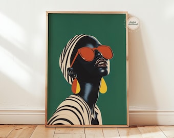 May include: A framed art print featuring a stylized portrait of a person with dark skin wearing orange sunglasses and teardrop earrings. The person is wearing a striped head covering and top against a green background.
