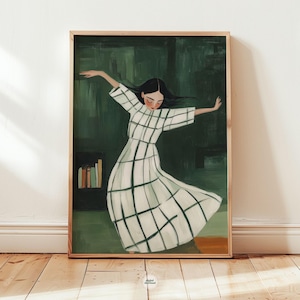 Puede incluir: Impresión artística enmarcada que representa a una mujer con un vestido blanco con un patrón de cuadrícula negra, con los brazos extendidos. El fondo es verde oscuro con una estantería. La obra está en un marco de madera.