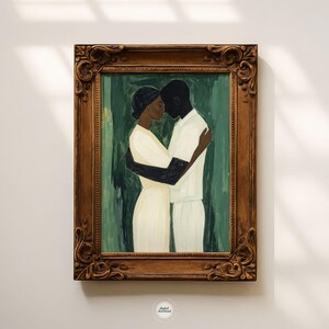 May include: A framed painting depicts two figures embracing. The figures are painted in a minimalist style, with one wearing a white outfit and the other a cream-colored dress. The background is a muted green, and the frame is ornate.