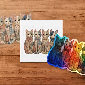 Quilted cat stickers in pastel and jewel tones are arranged on a wooden surface.