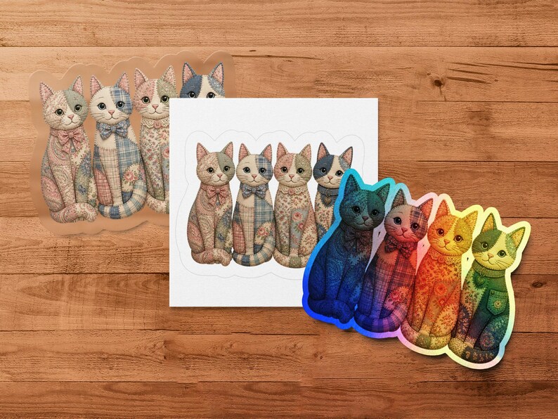 Quilted cat stickers in pastel and jewel tones are arranged on a wooden surface.