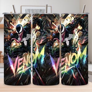 May include: Three stainless steel tumblers with the word "VENOM" in colorful, stylized text. Each tumbler features a detailed illustration of the Venom character with a white spider emblem on a black background. The tumblers have silver straws.