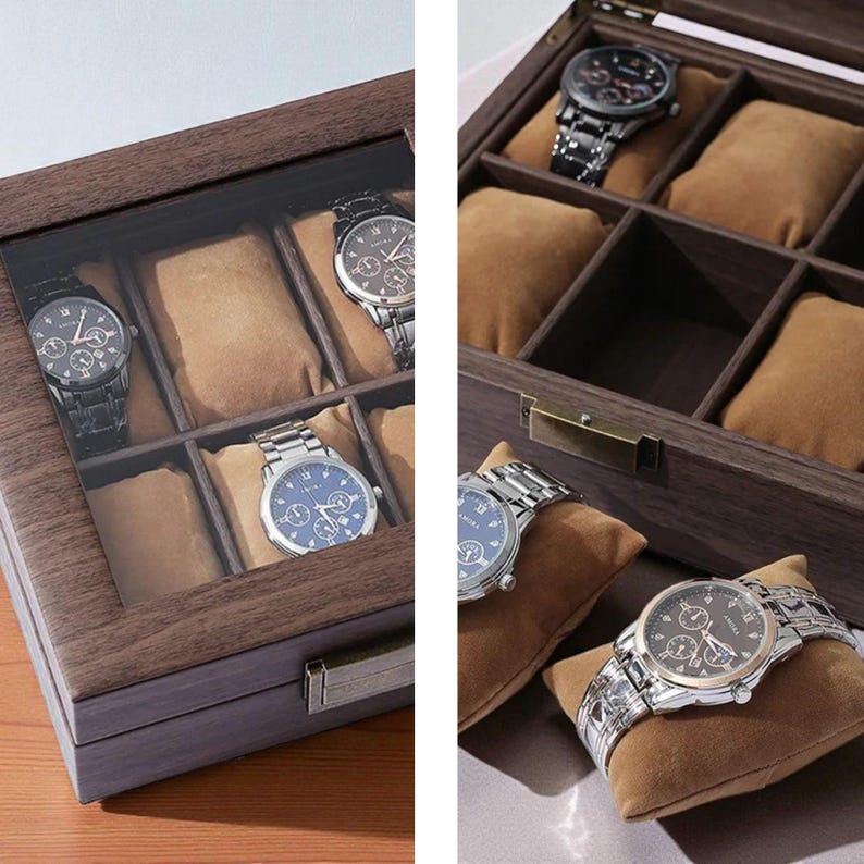 May include: A wooden watch display case with a glass top, showcasing several wristwatches. The case has multiple compartments with tan cushions to hold the watches. The watches have various band styles and face designs, including silver and black tones.