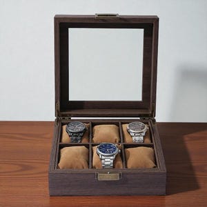 May include: A wooden watch display case with a glass top, showcasing six watches on brown cushions. The case is open, revealing the watches with various metal bands and faces. The wood has a dark brown finish.