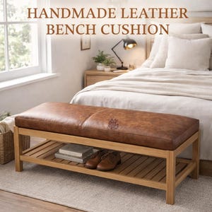 May include: Handmade leather bench cushion with a brown leather top and a wooden frame. The bench has a lower shelf for storage. The text "HANDMADE LEATHER BENCH CUSHION" is at the top of the image.