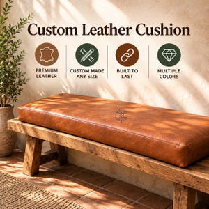 May include: A rectangular tan leather cushion sits on a wooden bench. Above the cushion, text reads Custom Leather Cushion with four circular icons labelled Premium Leather, Custom Made Any Size, Built To Last, and Multiple Colours.