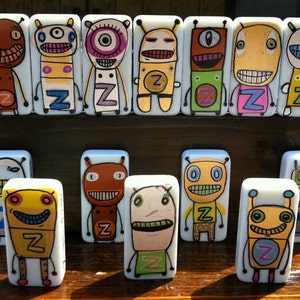 May include: A set of 14 colorful dominoes featuring cartoon characters with different expressions. Each domino has a letter 'Z' on it.