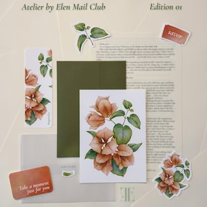 May include: A stationery set titled Atelier by Elen Mail Club Edition 01, featuring a green envelope, a floral print card, a bookmark with bougainvillea illustrations, two small stickers, and two rectangular cards with the text savor and Take a moment just for you.