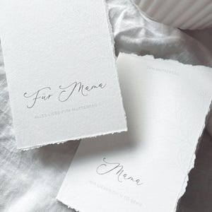 May include: A handmade wooden sign with the text "Welcome to our home" in a handwritten style. The sign is painted white with black lettering and a distressed finish, measuring approximately 30 cm wide.