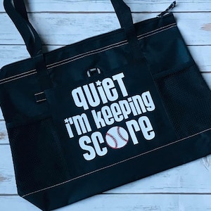 May include: Black tote bag with a white baseball and the text "quiet i'm keeping score".