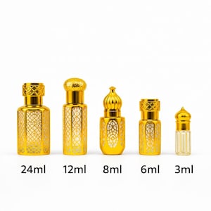 May include: Five gold-colored perfume bottles of varying sizes, ranging from 3ml to 24ml, are displayed against a white background. Each bottle has a decorative, ornate design and a matching cap. The sizes are labeled on the bottom.