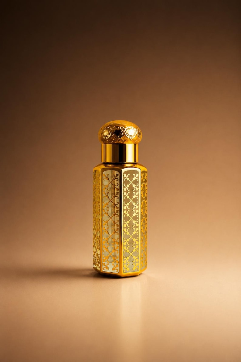 May include: A gold-colored perfume bottle with an ornate, filigree design. The bottle has a hexagonal shape and a decorative cap with a jeweled top. The background is a gradient of brown and gold.