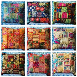 May include: Nine square decorative throw cushions with patchwork designs. Each cushion features a unique combination of colours and patterns, including floral and geometric motifs. The cushions are arranged on a blue patterned surface.