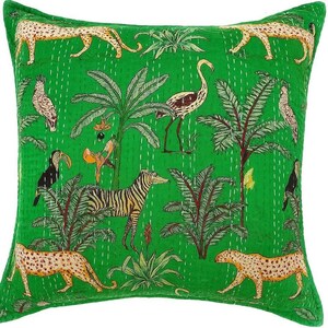 May include: Square green decorative pillow with a jungle-themed design. The pillow features illustrations of leopards, zebras, birds, and palm trees. The design is stitched onto the pillow with white thread.