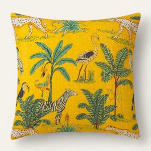 May include: A square yellow throw pillow with a jungle-themed design. The pillow features illustrations of zebras, leopards, flamingos, toucans, and palm trees. The design is in shades of green, black, and tan.