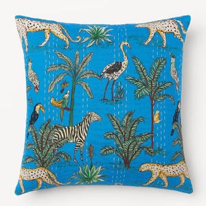 May include: Square throw pillow with a vibrant blue background featuring a jungle scene. The design includes zebras, leopards, birds, and palm trees. The pillow has a quilted texture with white stitching, adding a handcrafted feel.