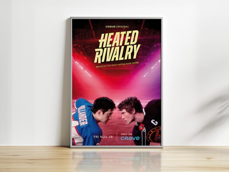 May include: A framed poster for "Heated Rivalry" featuring two hockey players facing each other. The poster has a red and purple background with the text "Crave Original" and "Based on the best-selling book series". The date "FRI NOV 28" is also visible.