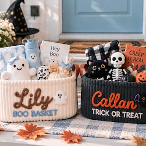 May include: Two oval corduroy baskets with leather handles. The white basket features the embroidered name Lily and the text BOO BASKET. The black basket features the embroidered name Callan and the text TRICK OR TREAT, filled with plush toys.