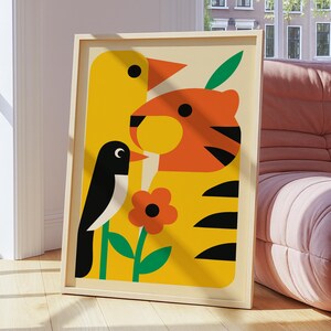 May include: A framed art print with a colourful illustration of a yellow bird, an orange tiger, and a black and white bird. A red flower and green leaves are also included. The artwork has a light beige background and is in a wooden frame.
