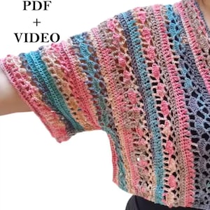 May include: A colorful, open-weave crochet top in shades of pink, blue, and gray. The top features a V-neck and short sleeves. The text "PDF + VIDEO" is in the upper left corner.