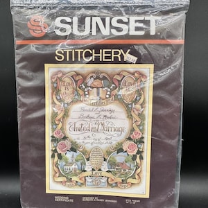 May include: A Sunset Stitchery wedding certificate kit. The kit includes a design with the text "United in Marriage" and the names Randal L. Jennings and Barbara L. Merind. The design features roses, doves, and the words "Love is Patient" and "Love is Kind."