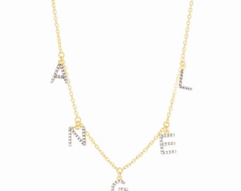 May include: A gold-colored necklace featuring the letters A, N, G, E, and L, each encrusted with small, sparkling stones. The letters are suspended from a delicate chain, creating a personalized and elegant accessory.