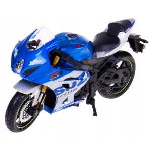 May include: A blue and white Suzuki GSX-R motorcycle model. The model features the Suzuki logo and Ecstar branding. The motorcycle has black tires with green accents, a black seat, and gold suspension components.
