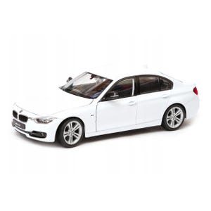 May include: A white BMW 330i sedan model. The car has a sleek design with silver alloy wheels and black tinted windows. The BMW logo is visible on the front grille. The car is set against a white background.