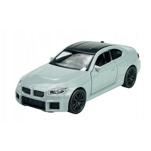 May include: A light gray die-cast model car with a black roof and black wheels. The car has a detailed front grille and headlights, and a sleek, aerodynamic design. The model car is a miniature replica of a sports car.