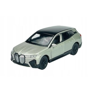 May include: Silver and black model SUV with black wheels. The miniature car has a black roof and a detailed front grille. The toy car is a replica of a modern vehicle.