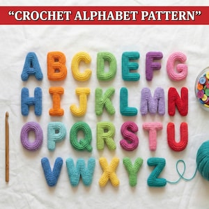May include: A colorful crochet alphabet pattern is displayed, featuring letters in various hues like blue, orange, green, and purple. The letters are arranged on a white surface, with a crochet hook, buttons, and yarn visible.