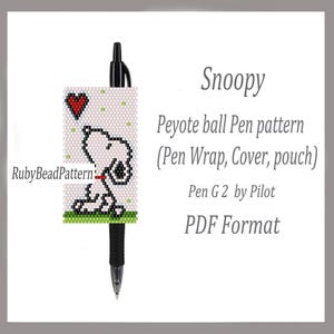 May include: A black Pilot G2 pen with a beaded Snoopy pen wrap. The wrap features a white background with a red heart and a cartoon Snoopy design. The text on the wrap says "Peyote ball Pen pattern".
