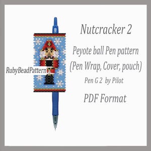 May include: A blue Pilot G2 pen with a beaded pen wrap featuring a Nutcracker design. The pen wrap is blue with a Nutcracker figure in red, black, and tan. The text "Nutcracker 2" and "Peyote ball Pen pattern" are visible.