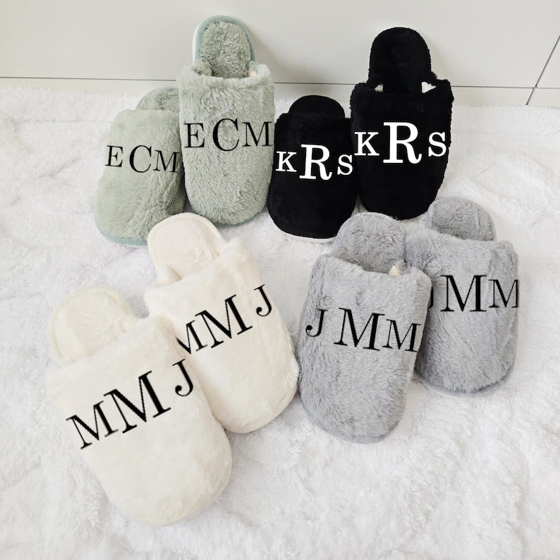Group of personalized slippers with initials printed on them — perfect for groomsmen or family gifts, shown in multiple colors.