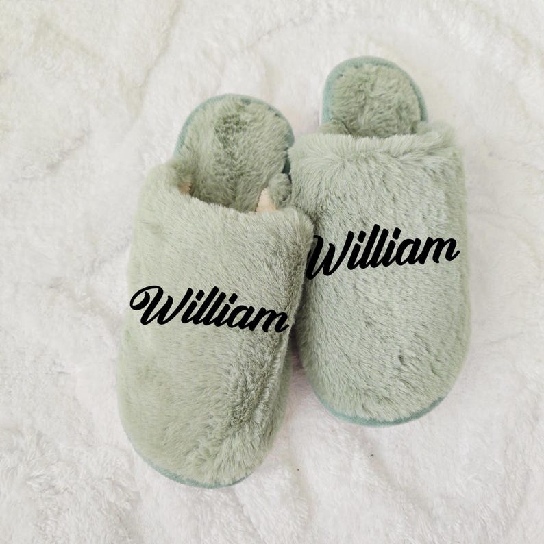 Sage green personalized slippers with the name William, displayed on fluffy white background — cozy custom gift idea.