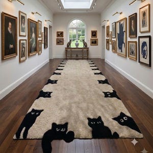 May include: A long, rectangular beige runner rug featuring a repeating pattern of black cat silhouettes along both edges. The cats are depicted in various poses, with some appearing to peek from the sides and others fully visible on the rug surface.