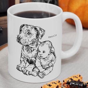 May include: White ceramic mug featuring a black and white illustration of a dog and a baby. The word "Gentle" is printed on the mug. The mug contains a dark liquid and has a white handle.