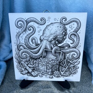 May include: Black and white illustration of an octopus with a treasure chest, anchor, and coral. The octopus has detailed tentacles and is centered above the open chest filled with jewels. The artwork is on a square, white tile.