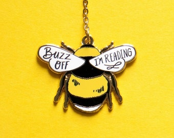 May include: A gold bee-shaped bookmark with the words "Buzz Off I'm Reading" on the wings.