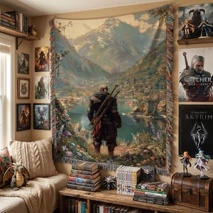 May include: A large tapestry showing a landscape with a figure in the foreground, swords on their back, overlooking a lake and mountains. The tapestry has a fringed edge and is hung on a wall with framed artwork and shelves of books.