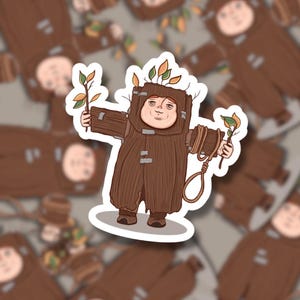 May include: A sticker depicting a cartoon character in a brown tree costume, holding branches with leaves. The character has a smiling face and is surrounded by other stickers with the same design. A noose hangs from the character's arm.