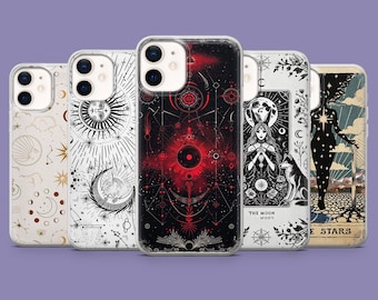 May include: Five phone cases with mystical designs, including celestial and tarot themes. The cases feature illustrations of the sun, moon, and stars in black, white, and red. The cases are arranged in a row against a purple background.