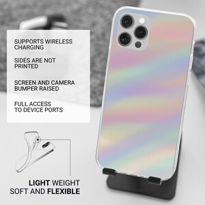 May include: A clear phone case with a colorful, iridescent design. The case is on a black stand. Text on a white card reads: Supports wireless charging, sides are not printed, screen and camera bumper raised, full access to device ports, light weight, soft and flexible.