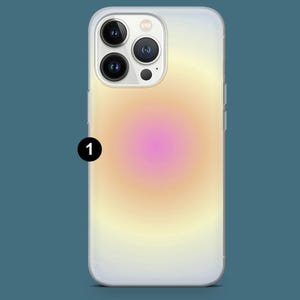 May include: A clear phone case with a gradient design. The design transitions from a pink center to yellow and white edges. The phone case has a camera cutout and side buttons.