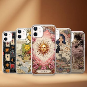 May include: Five phone cases with tarot card artwork. The designs include the sun, a woman with cats, and a dancer. The cases have clear edges and a glossy finish. The cases are designed for a smartphone.