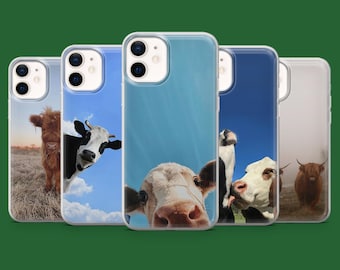 May include: A collection of five phone cases featuring close-up images of cows. The cases display various cow breeds against blue sky backgrounds and grassy fields. Each case has a clear, protective bumper.