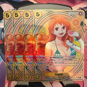 May include: A white ceramic mug with a black handle and the text "But First, Coffee" in a bold, black font. The mug is set against a blurred background, suggesting a cozy setting.