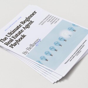 May include: A stack of white paperbacks titled "The Ultimate Beginner Real Estate Agent Playbook" by Bellamy. The cover features light bulbs and text. The book is designed for real estate agents.